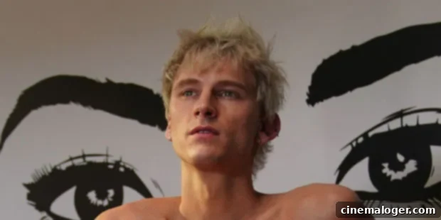 MGK's Shocking Admission: Almost Shot Himself on Call With Megan Fox 3 Machine Gun Kelly performing on stage under pink lights, holding a microphone.