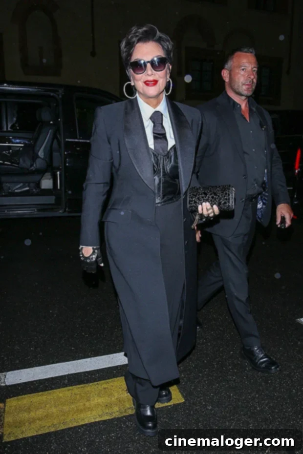 Kim K and Mom Kris Go Glam in Silver at D&G Post-Show 3 Kris Jenner attending the Dolce & Gabbana after-party in a black tuxedo-inspired suit.