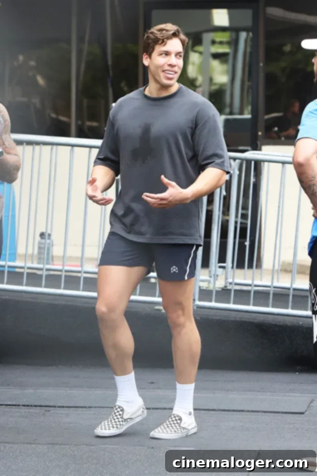 Joseph Baena Pumps Iron With Dad Arnold Schwarzenegger, Strengthening Family Ties Amidst DWTS Demands 2 Joseph Baena and Arnold Schwarzenegger working out together at Gold's Gym, Joseph focusing on chest exercises.