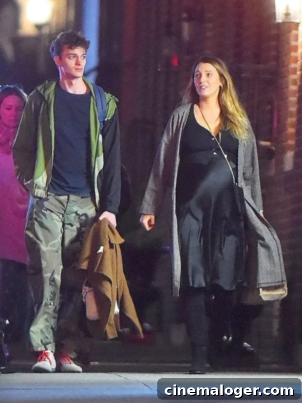 Blake Lively Flaunts Her Baby Bump On NYC Streets 2 Blake Lively looking elegant in a black silky dress and coat during a New York City stroll, showcasing her baby bump.