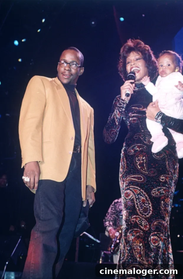 Bobbi Kristina Brown: The Tragic Story of Whitney Houston's Daughter 3 Bobby Brown, Whitney Houston, and baby Bobbi Kristina Brown on stage