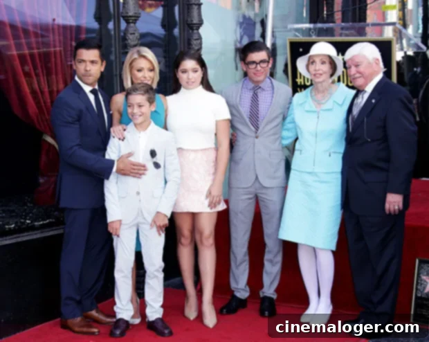 Kelly Ripa's 2022 Holiday Card Reveals Her Three Grown Up Kids 2 Kelly Ripa and Mark Consuelos with their three children, Michael, Lola, and Joaquin, at Kelly's Hollywood Walk of Fame ceremony in 2015, showcasing their family's bond.