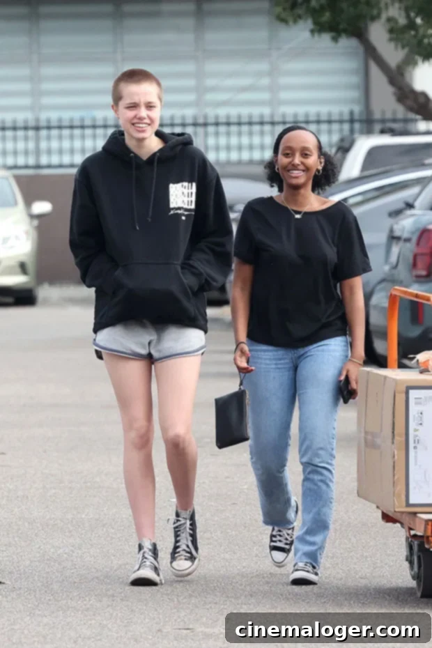 Shiloh Jolie-Pitt, 16, Reveals Dramatic Buzz Cut On Shopping Spree With Sister Zahara, 18 Before And After Photos 2 Shiloh Jolie-Pitt and Zahara Jolie-Pitt smiling during a casual shopping trip, Shiloh debuting her new buzz cut.