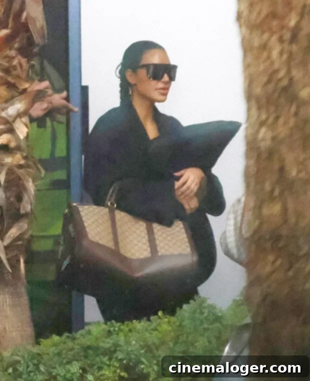 Kim Kardashian and Khloe Console Grieving Tristan Thompson After Mother's Passing 3 Kim Kardashian, dressed in all-black, gracefully boarding a flight from Toronto, signaling her supportive role for Khloe during a period of family mourning.