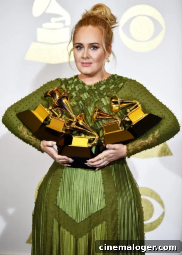 Adele Grammy Tally A Complete List of Her Awards 3 Adele accepting an award, smiling at the microphone.