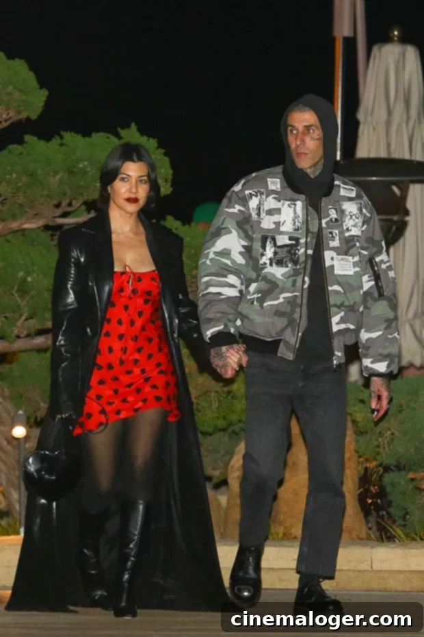 Kourtney and Travis's Family Dinner Night Out with Reign and Landon 2 Kourtney Kardashian and Travis Barker holding hands outside Nobu Malibu