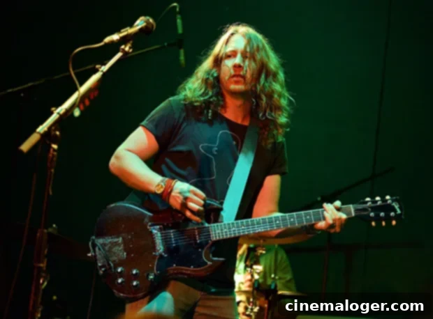 Ben Kweller Ed Sheeran Partner The Tragic Loss Of His 16 Year Old Son 2 Ben Kweller, the musician, performing on stage with a microphone and guitar.