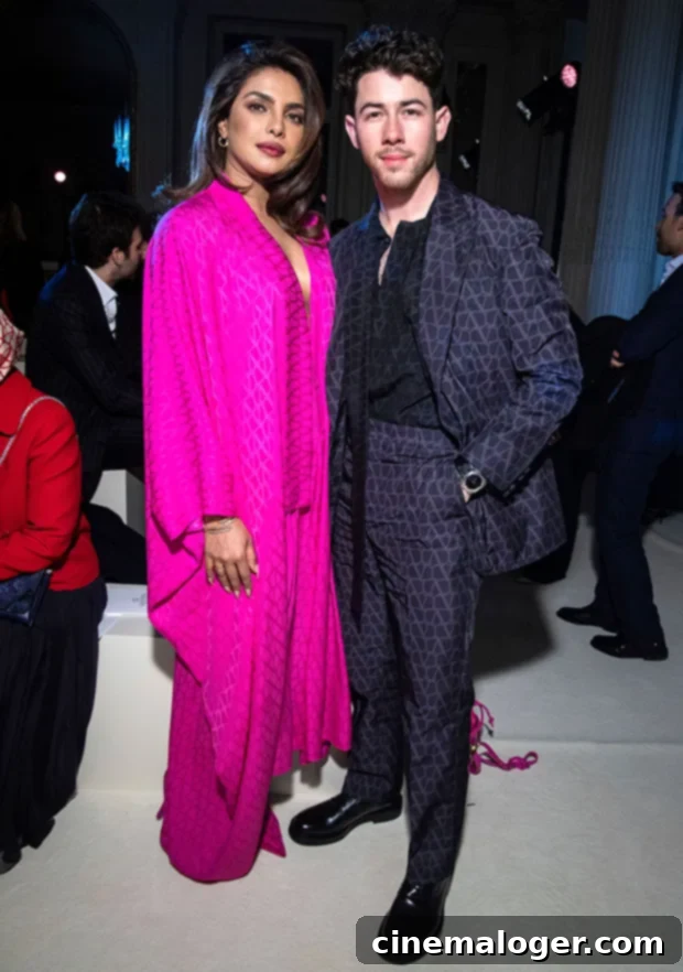 Priyanka and Nick's Pink Paris Fashion Week Statement 3 Priyanka Chopra and Nick Jonas posing together at the Paris Fashion Week event in their coordinated Valentino outfits.