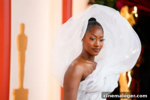 Tems' Controversial Oscars Gown Creates Social Media Firestorm 2 Tems arrives at the Oscars in a voluminous white dress, making a grand entrance on the red carpet.