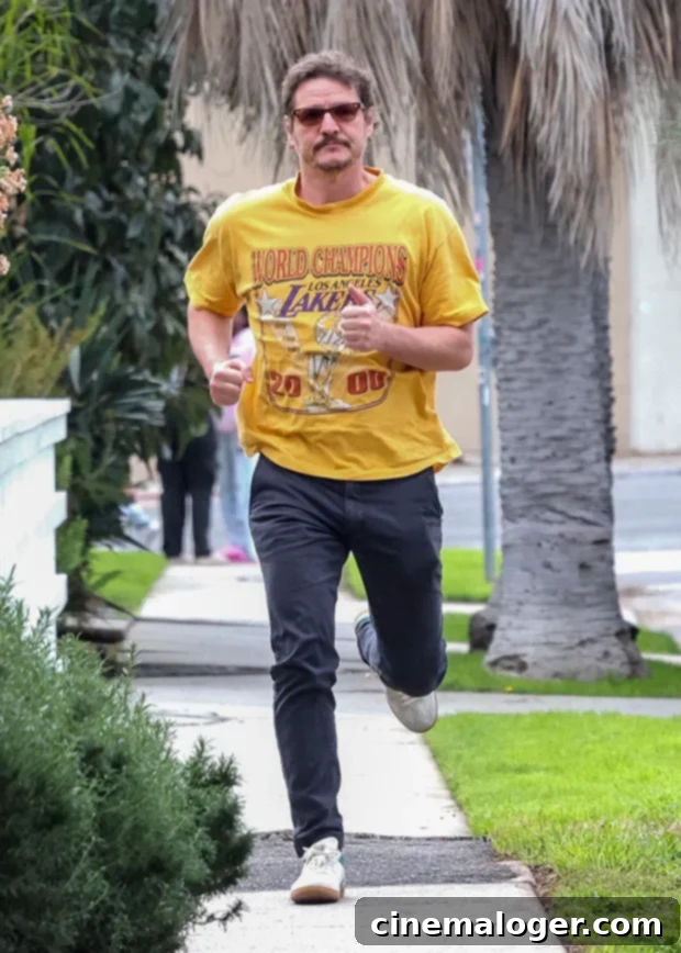 From Errands to Escape: Pedro Pascal's Speedy Exit in LA 2 Pedro Pascal jogging back to his car in Los Angeles, wearing a vintage Lakers shirt.