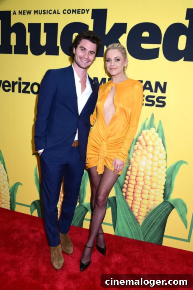 Kelsea Ballerini and Chase Stokes Confirm Romance at Shucked Premiere 2 Kelsea Ballerini and Chase Stokes smiling and posing on the red carpet at the Shucked premiere. Kelsea is wearing a yellow mini dress and Chase is in a navy suit.