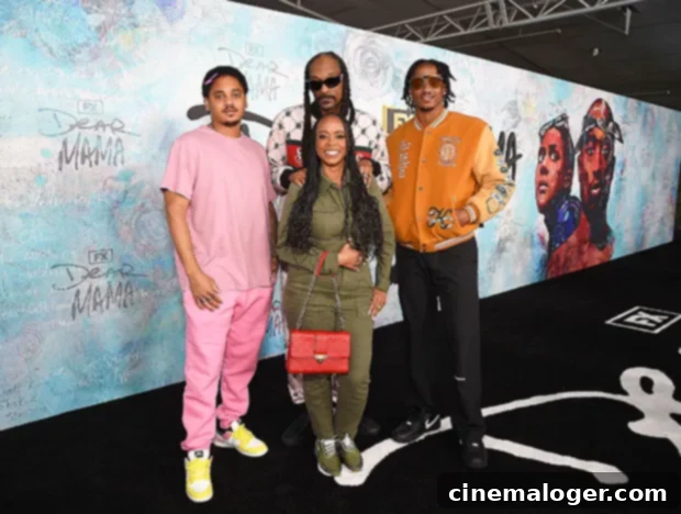 Snoop Dogg's Premiere Night A Family Portrait 2 Snoop Dogg and Shante Broadus, dressed stylishly, pose together on the red carpet at the 'Dear Mama' docuseries premiere.