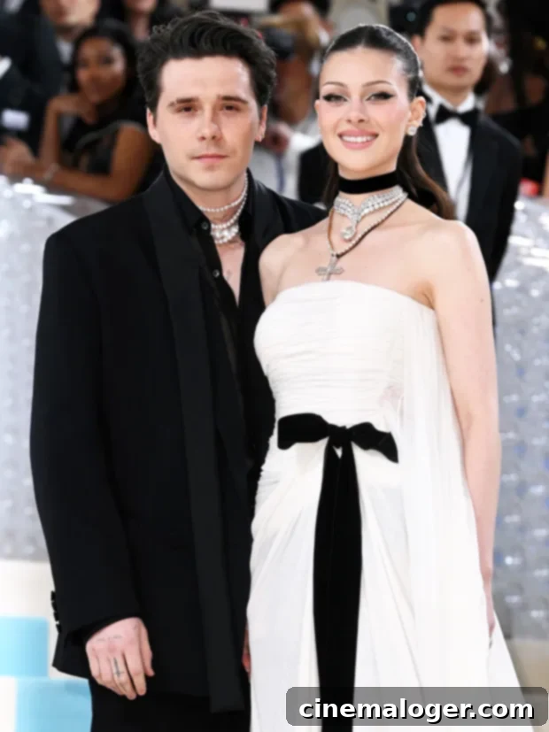 Brooklyn & Nicola Peltz Stun in Monochrome at Met Gala 2023 2 Nicola Peltz Beckham at the 2023 Met Gala in an ethereal white gown cinched with a black bow.