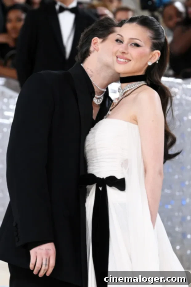 Brooklyn & Nicola Peltz Stun in Monochrome at Met Gala 2023 3 Brooklyn Beckham at the 2023 Met Gala, sporting a black suit, mesh top, and Mikimoto pearls.