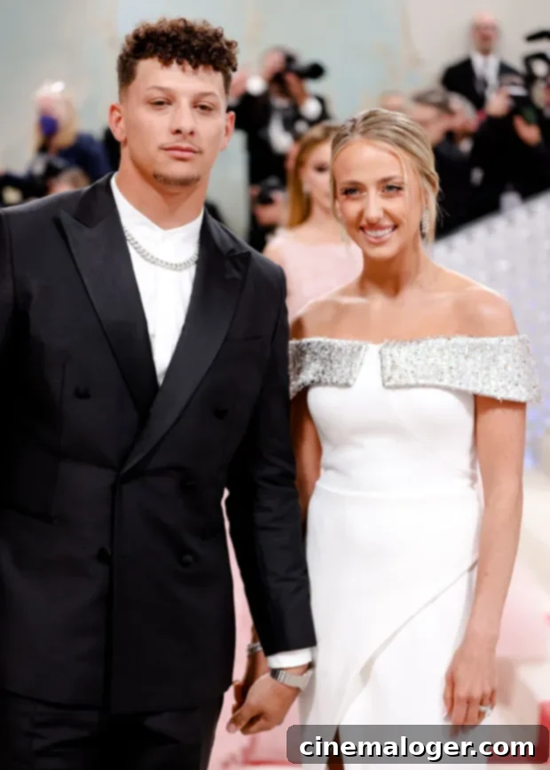 Post-Baby Glow: Brittany Mahomes Makes Dazzling Met Gala Debut In White With Patrick 2 Brittany Mahomes radiating elegance in a white strapless gown with sparkling details, accompanied by Patrick Mahomes in a sharp black suit at the 2023 Met Gala red carpet.