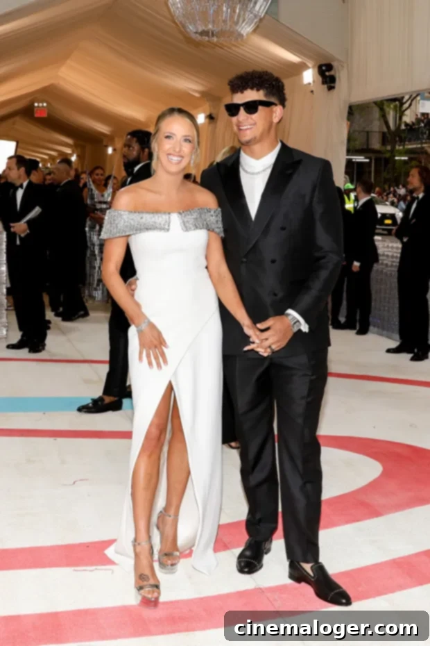 Post-Baby Glow: Brittany Mahomes Makes Dazzling Met Gala Debut In White With Patrick 3 Brittany Mahomes in a stunning white gown and Patrick Mahomes in a black suit, posing elegantly at the 2023 Met Gala, celebrating six months since welcoming their second child.
