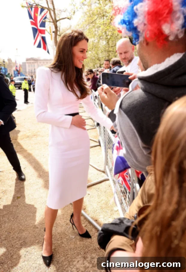 King Charles, William, and Kate Meet Crowds Ahead of Coronation 3 Kate Middleton was a vision in white greeting fans a day before the coronation.