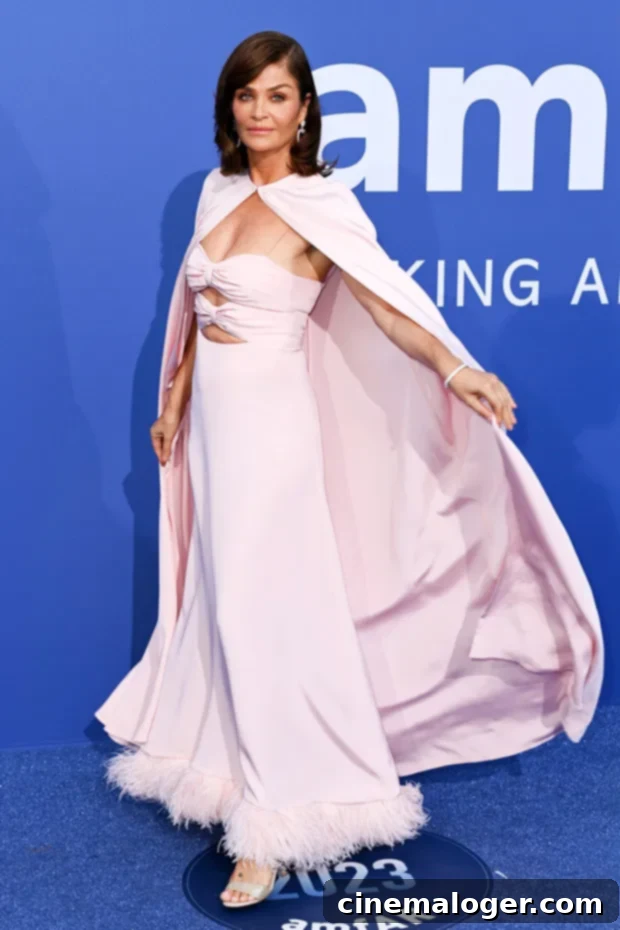 Helena Christensen Commands Attention in Breathtaking Cape Gown at Cannes amfAR Gala 3 Helena Christensen's elegant cape adds a dramatic flair as she poses for photos.