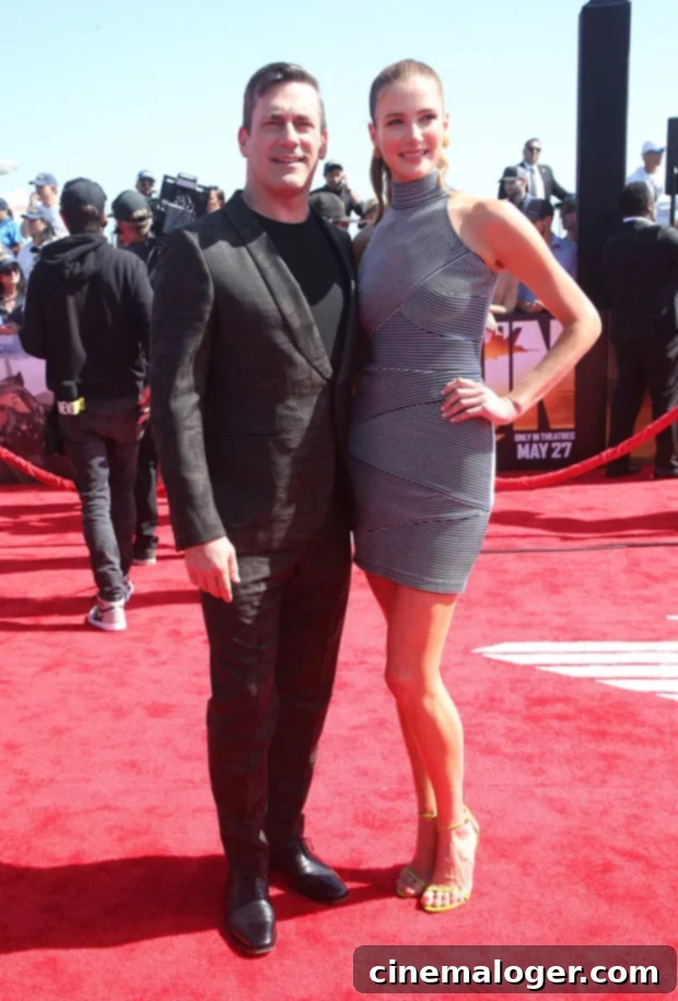 Jon Hamm and Anna Osceola smiling and holding hands