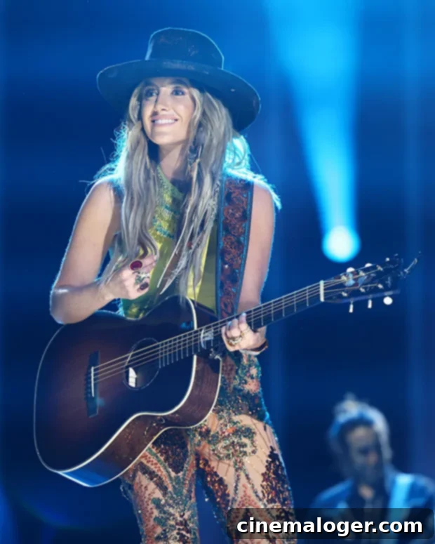 Lainey Wilson Previews Evolved Music, Embracing Growth and a Grounded Chapter 2 Lainey Wilson performing with her guitar on stage.