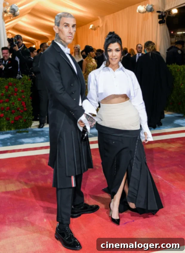 Pregnant Kourtney Kardashian And Travis Barker Leave Hospital After Urgent Family Matter 3 Travis Barker and Kourtney Kardashian attending the MET Gala, a testament to their high-profile relationship.