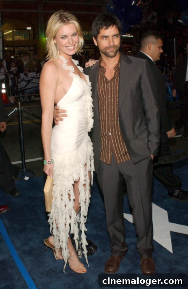Inside John Stamos' Marriage to Rebecca Romijn 3 John Stamos and Rebecca Romijn smiling on a red carpet at the X-Men 2 premiere.