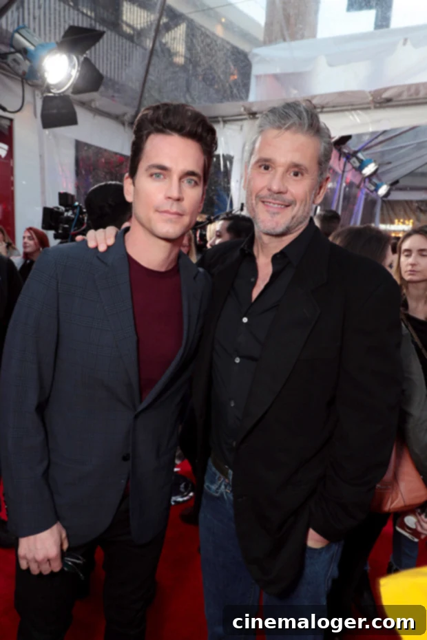 Inside Matt Bomer's Marriage: A Look at the 'Fellow Travelers' Star's Spouse 2 Matt Bomer and Simon Halls smiling and embracing at a movie premiere event. Matt is wearing a dark suit, and Simon is in a grey suit.