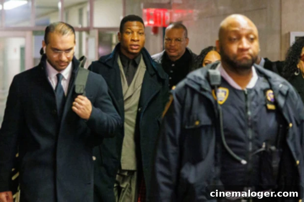 Jonathan Majors' First TV Interview After Guilty Verdict 2 Jonathan Majors in a suit leaving the courthouse during his assault trial.
