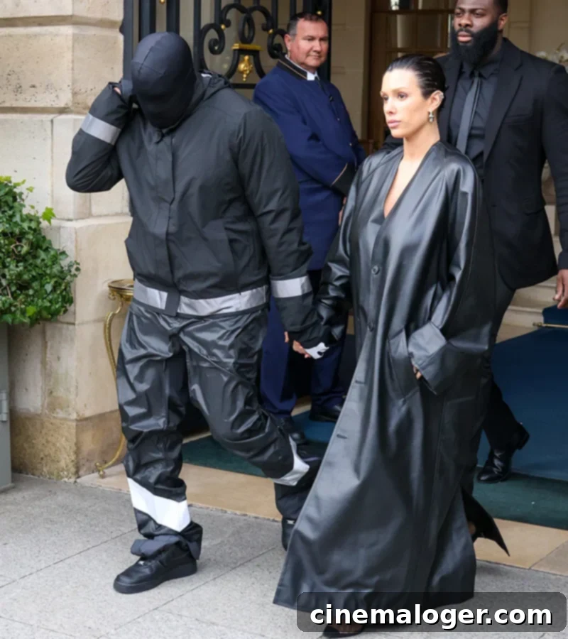 Kanye West's Wife Bianca Censori's Daring White V-Neck Dress Steals Spotlight 2 Kanye West and Bianca Censori walking out of a hotel