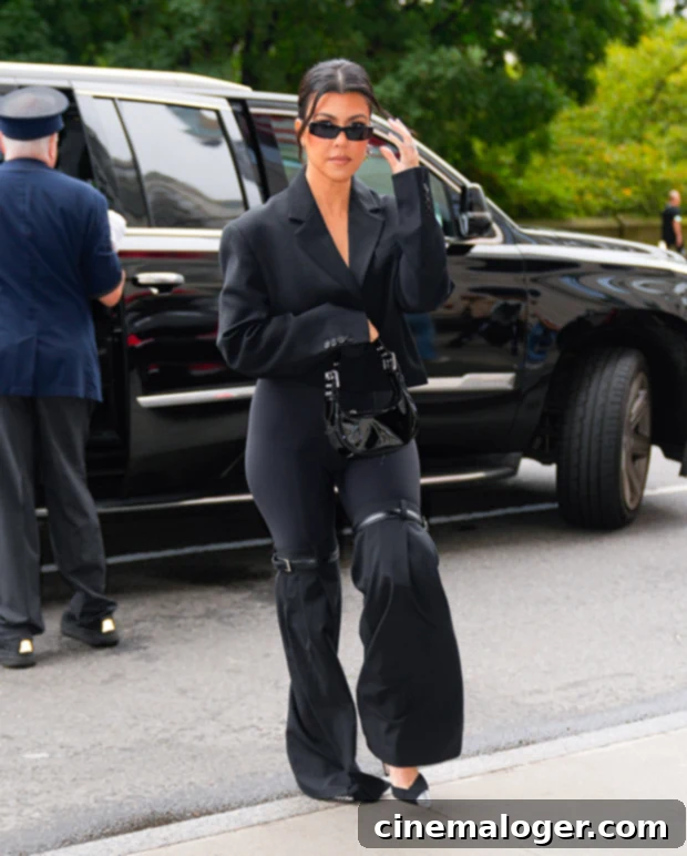 IHOP Birthday Bash: Kourtney Kardashian Rings in 45 with Friends 2 Kourtney Kardashian posing elegantly in a bikini during her tropical 45th birthday celebration.