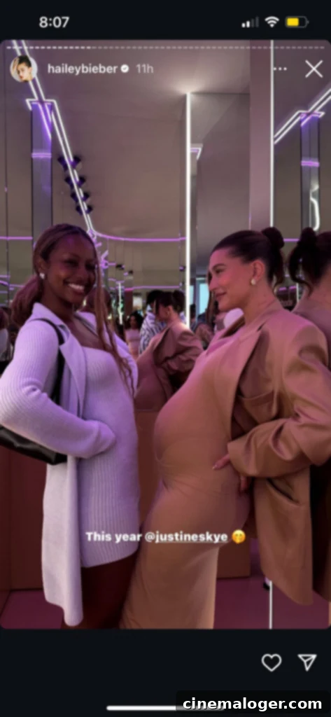 Hailey Bieber's Baby Bump Revealed in Adorable Photo Alongside Justine Skye 2 Hailey Bieber and Justine Skye smiling together at the Rhode pop-up