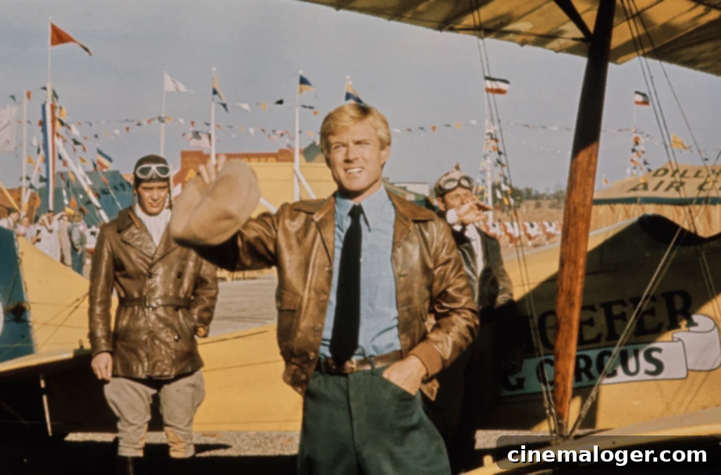 Honoring Robert Redford: A Legendary Icon's Final Tribute 3 American actor Robert Redford, wearing a brown leather jacket over a blue shirt with a black tie, his cap in his right hand, with American actor Scott Newman, who wears a brown leather jacket, white scarf, an aviator's cap and flying goggles, a 'Dillhoefer's Flying Circus' biplane, bunting and flags in the background, in a publicity still from 'The Great Waldo Pepper', filmed in Elgin, Texas, 1975. The aviation drama, directed by George Roy Hill, starred Redford as Waldo Pepper. (Photo by Michael Ochs Archives/Getty Images)