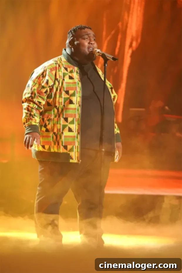 Willie Spence smiling with a microphone, during his American Idol journey.