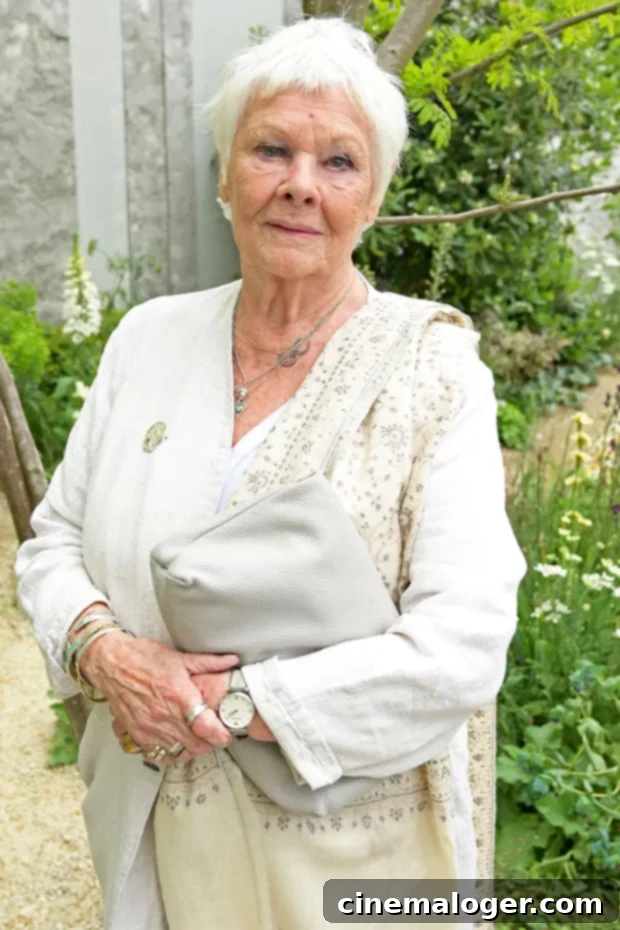 Judi Dench smiling, looking elegant in a dark dress