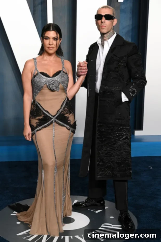 Kourtney Kardashian & Travis Barker pose on the red carpet at Vanity Fair Oscars After-Party